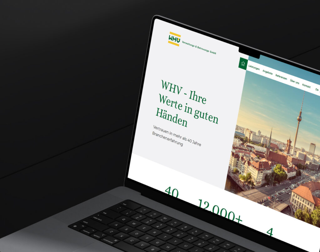 Laptopbildschirm zeigt Webseite der WHV Verwaltung mit Slogan und Stadtbild von Berlin